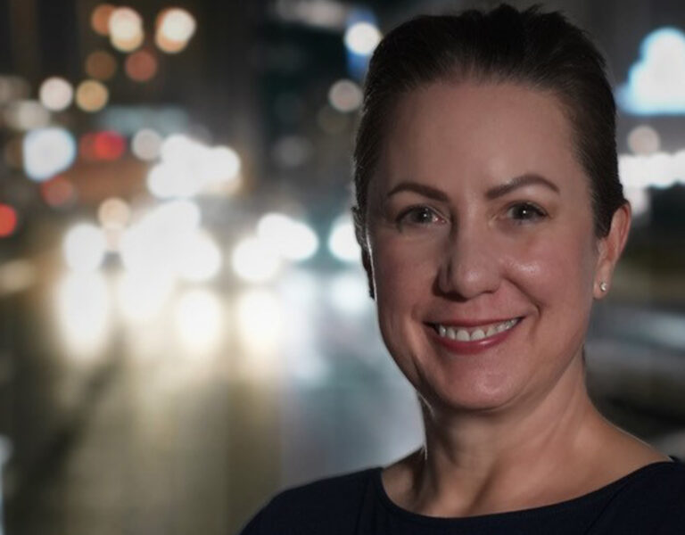 A woman smiling into camera